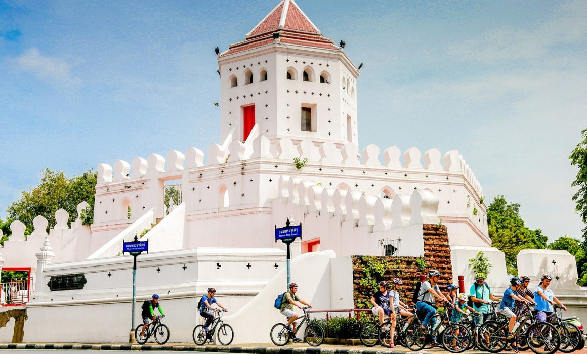 White Phra Sumen Fort with group of cyclists in front in Bangkok