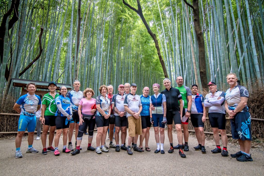 Group of cyclists in bamboo forest in Japan