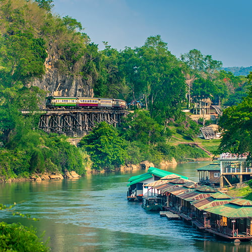 Burma railway train in the distance, river with floating buildings