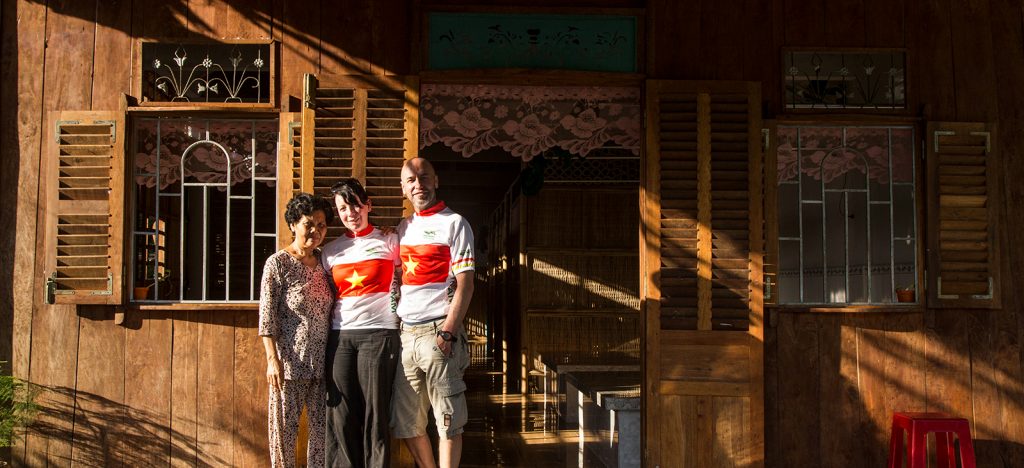 Homestay in Vietnam, with man and woman standing with Vietnamese host