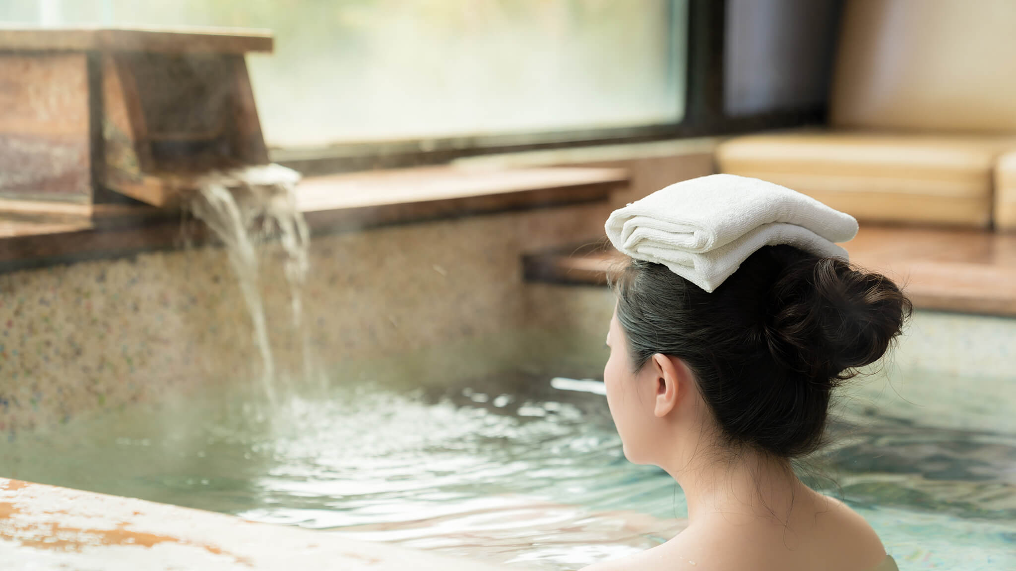 Woman in Onsen with towel