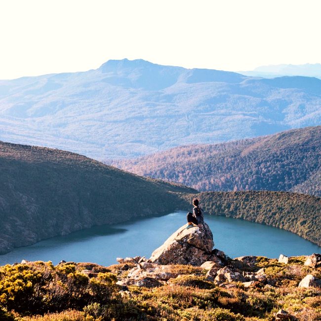 Trekking girl with lake view in Tasmania