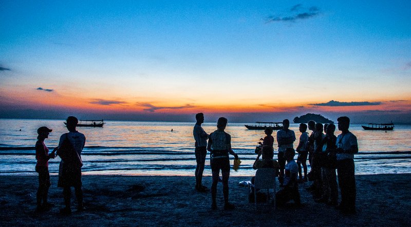 Tour group Sunset on beach in Cambodia