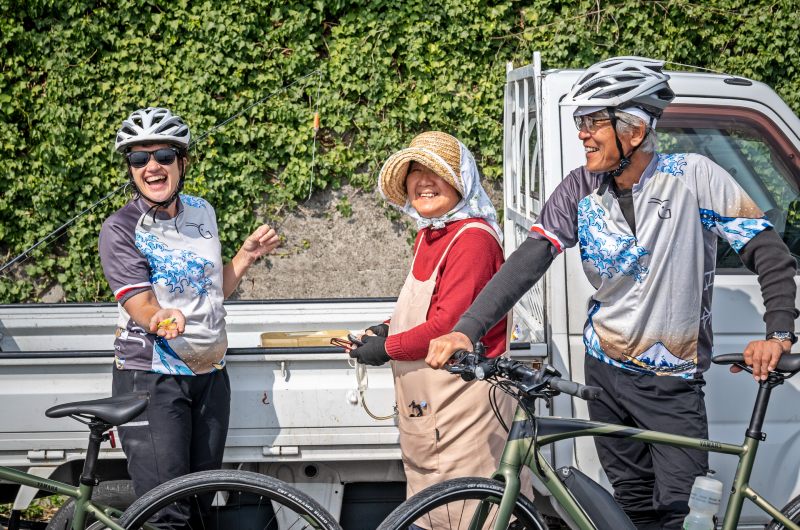 Cyclist interacting with local Japanese on a bike tour of Japan.