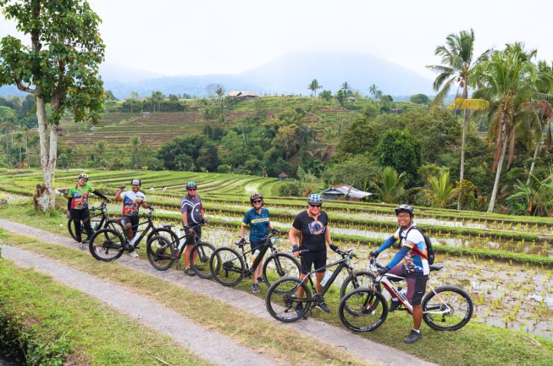 Enjoying a scenic ride through the vibrant green Jatiluwih Rice Terrace in Bali.